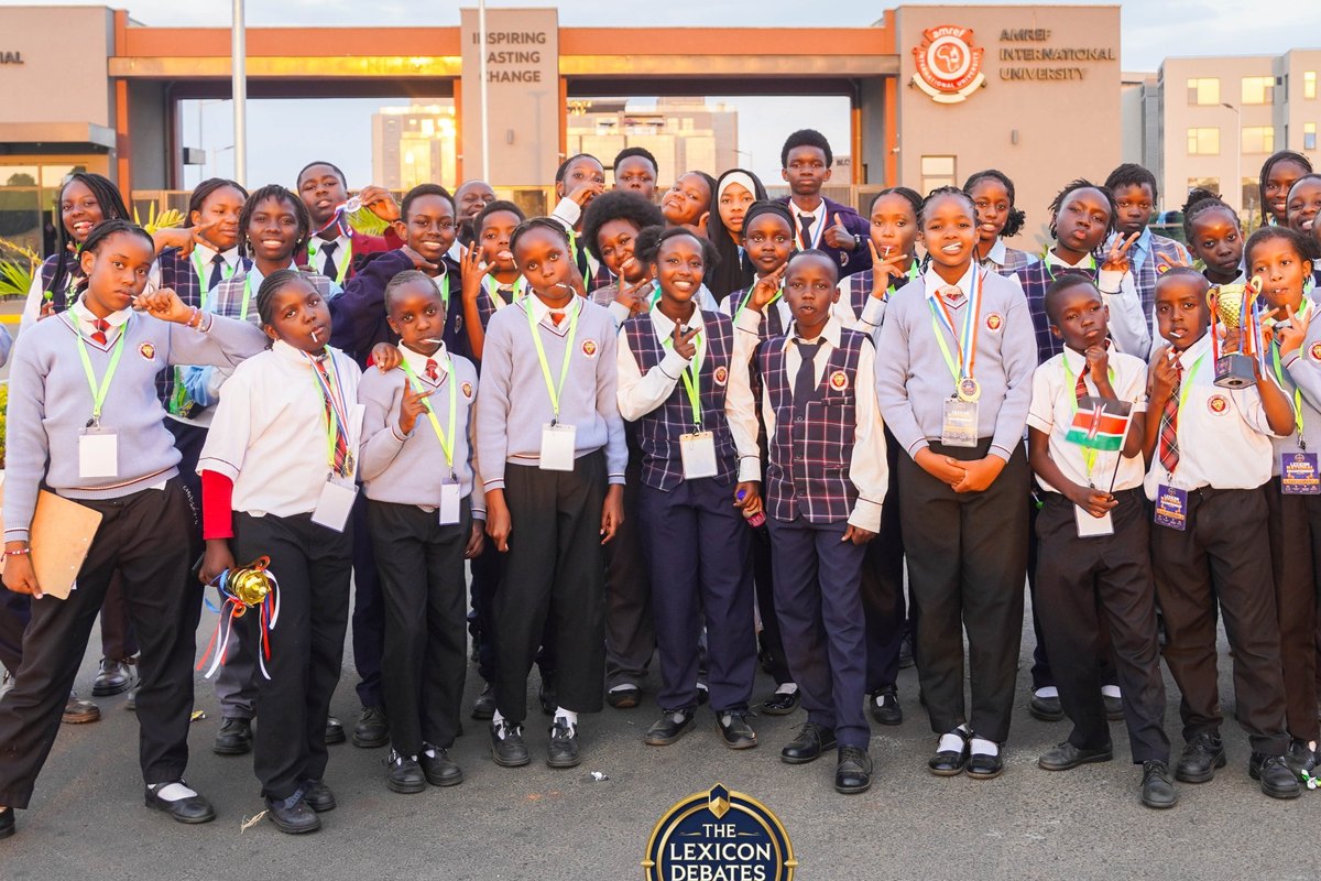 Students celebrating with trophies outside Amref International University