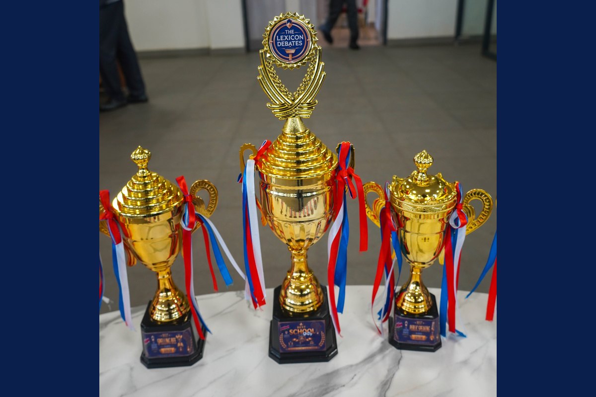 Gold Lexicon Debates trophies with red, white and blue ribbons
